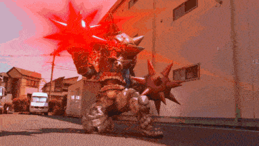 a robot with spikes on its arms is standing in front of a building with the number 3 on it