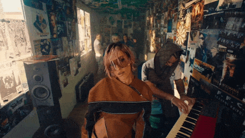 a woman is playing a piano in a room with posters on the wall including one that says ' ff ' on it
