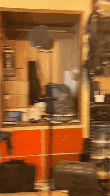 a blurred image of a room with a lot of boxes on the shelves