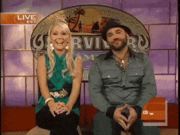 a man and a woman sitting in front of a survivor logo