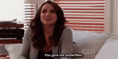 a woman is sitting on a couch and saying you give me butterflies