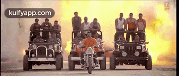 a group of men are riding motorcycles in front of a group of jeep .