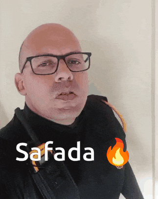 a bald man wearing glasses and a black shirt with the word safada on it