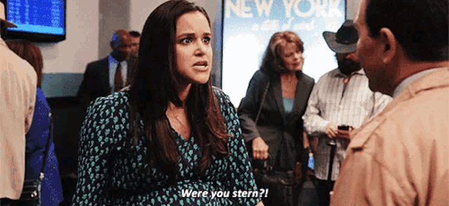 a woman says were you stern in front of a sign that says new york