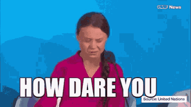a woman is sitting in front of a microphone and says how dare you