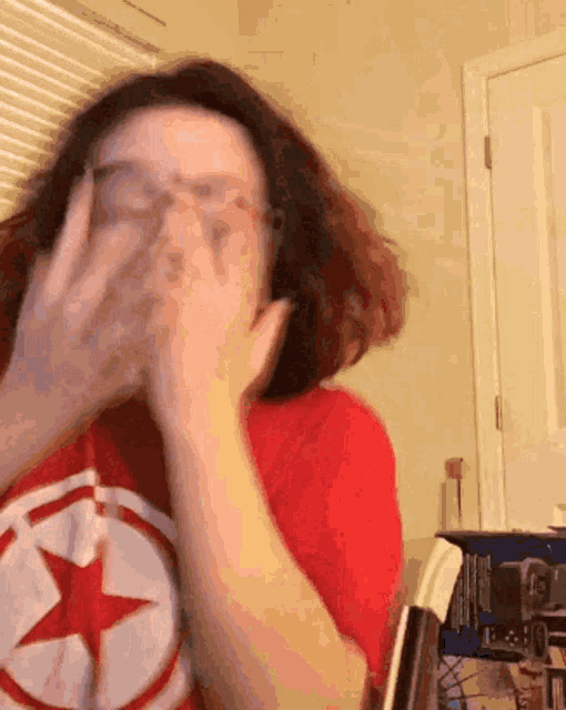 a woman wearing a red shirt with a star on it
