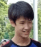 a young boy in a blue and black shirt is smiling .