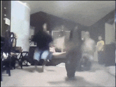 a blurry picture of people dancing in a room