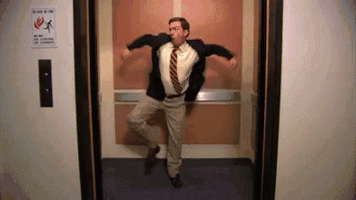 a man in a suit and tie is jumping out of an elevator door .