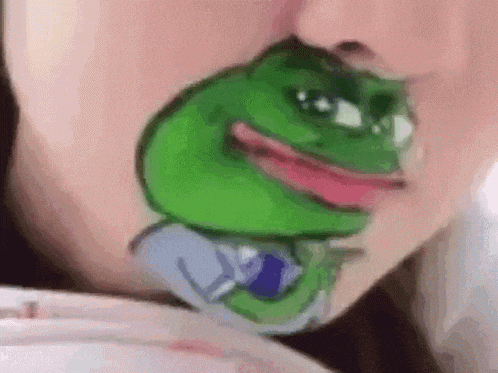 a person with a green frog painted on their face .