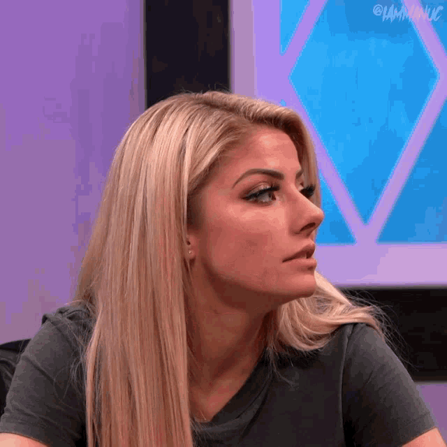 a close up of a woman 's face with a purple background and a watermark that says i am manic