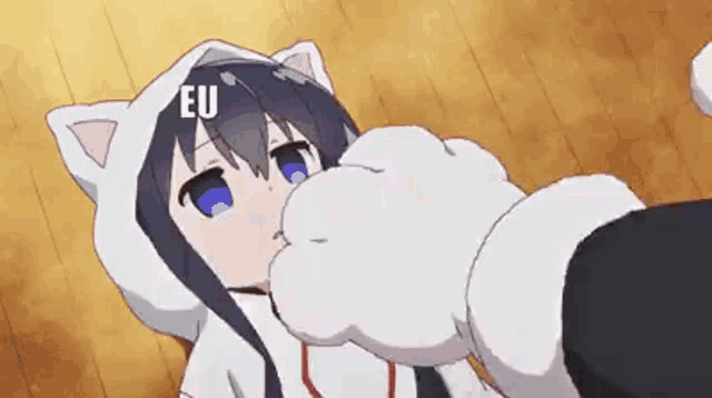 a girl in a cat costume is laying on the floor with a cat paw on her face .