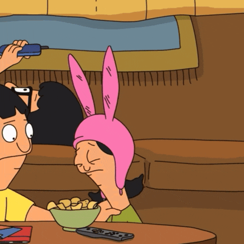 bob and lou from bob 's burgers are sitting on a couch with a bowl of chips