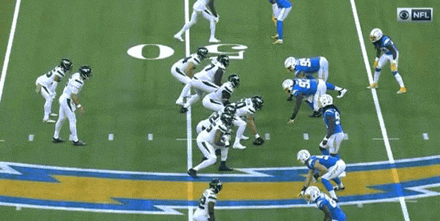 a group of football players on a field with a nfl logo