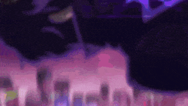 a blurry picture of a purple and pink background with a purple circle in the middle