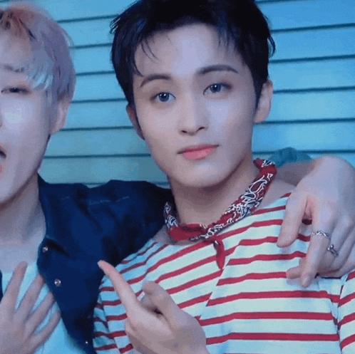 two young men are posing for a picture and one of them is wearing a red and white striped shirt