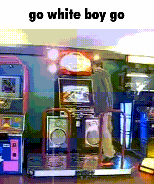 a man is standing in front of an arcade machine with the words go white boy go above him