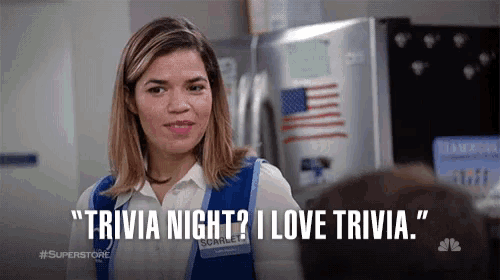 a woman says " trivia night i love trivia " in front of a refrigerator