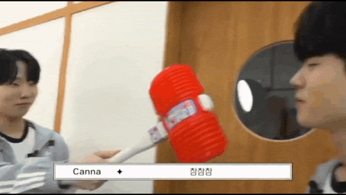 a person holding a red hammer that says canna