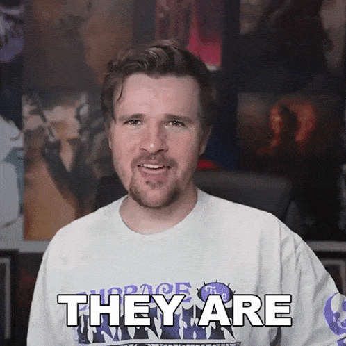 a man wearing a white shirt with the word they are on it