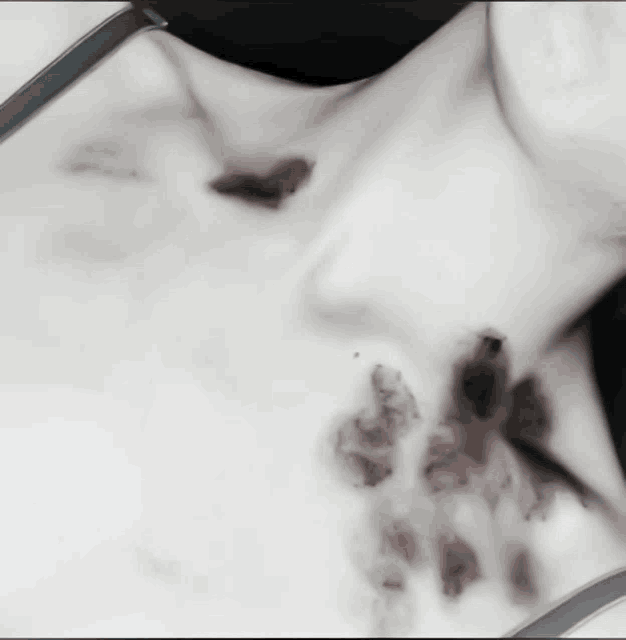 a close up of a woman 's neck with a black bra