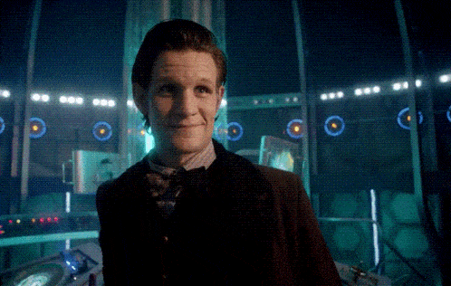 a man in a suit and tie is standing in front of a sign that says that is
