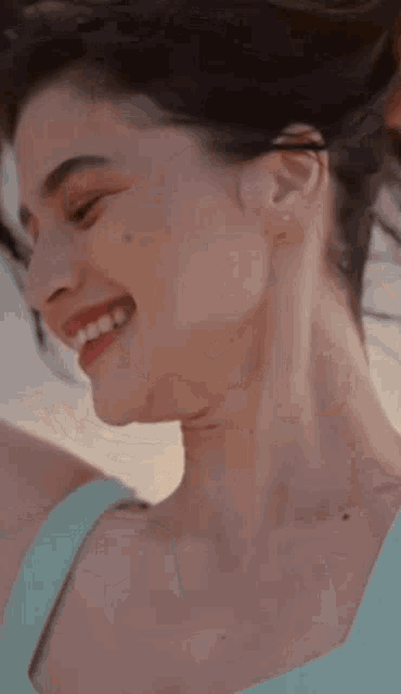 a close up of a woman 's face with her hair blowing in the wind .