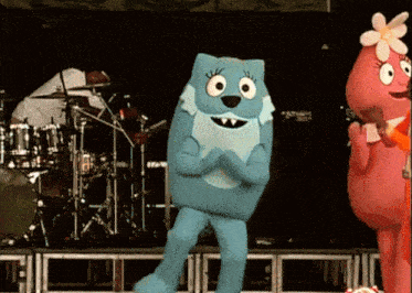 a group of cartoon characters are dancing on a stage