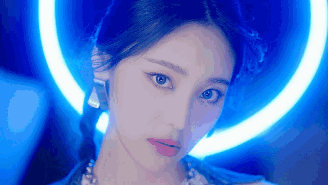 a close up of a woman 's face against a blue background