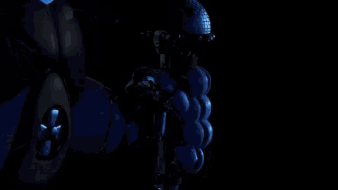 a robotic hand is giving a thumbs up in the dark .