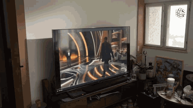 a large flat screen tv shows a man on stage