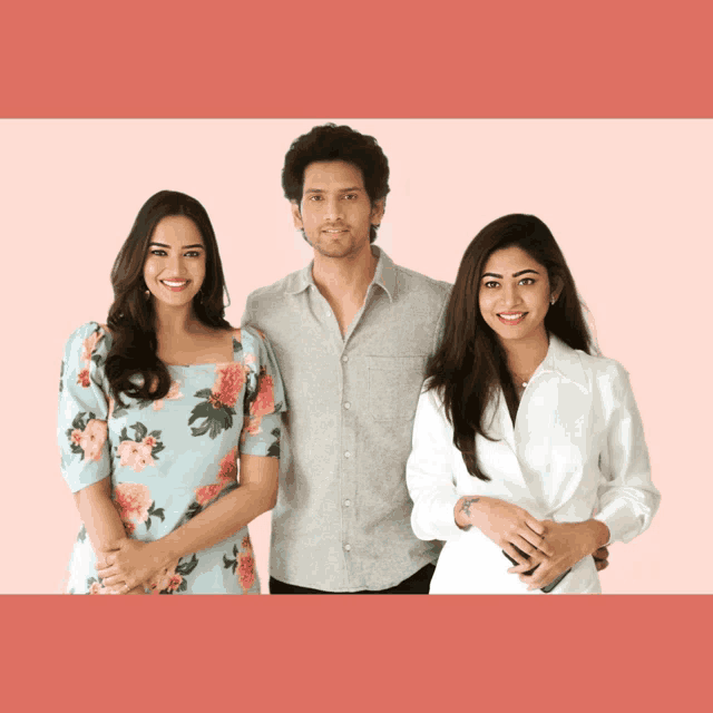 a man and two women are posing for a photo