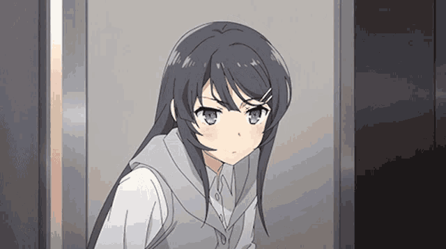 a girl with long black hair and blue eyes is looking at the camera