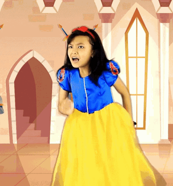 a little girl in a snow white costume is standing in front of a pink castle