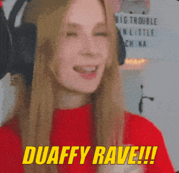 a woman wearing headphones and a red shirt says duaffy rave !!!