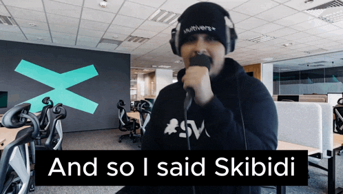 a man singing into a microphone with the words " and so i said skibidi " above him