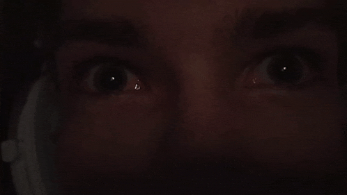a close up of a man 's eyes in the dark