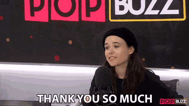 a woman says " thank you so much " in front of a pop buzz sign