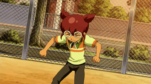 a boy with red hair and glasses stands in front of a fence