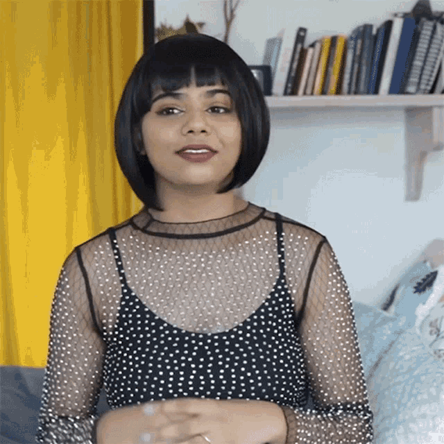 a woman in a black and white polka dot top