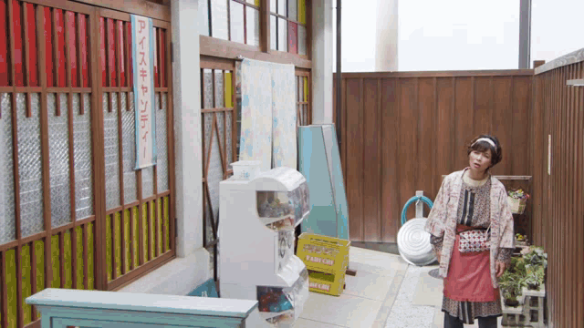 a woman stands in a room with a sign that says ' ice cream ' on it