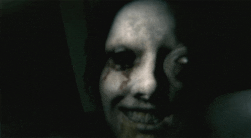 a close up of a scary face with blood coming out of its eyes