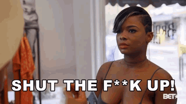a woman says shut the f * k up while holding a phone