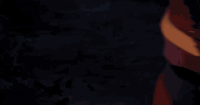 a man in a cape is holding a sword with flames on it
