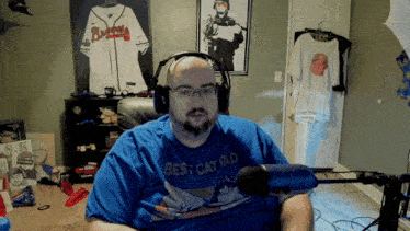 a man wearing a blue shirt that says best catdad