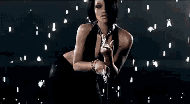 a woman is holding a gun in a dark room .