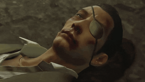 a man with a bandage on his eye is laying down and says i don 't really care
