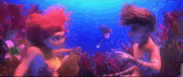 a boy and a girl are swimming in the ocean together .
