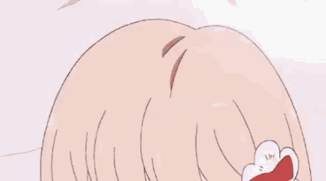 a girl is laying on her back on a bed in a room with a desk .