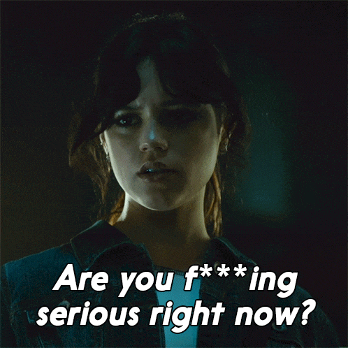 a woman in a dark room with the words " are you f *** ing serious right now " above her